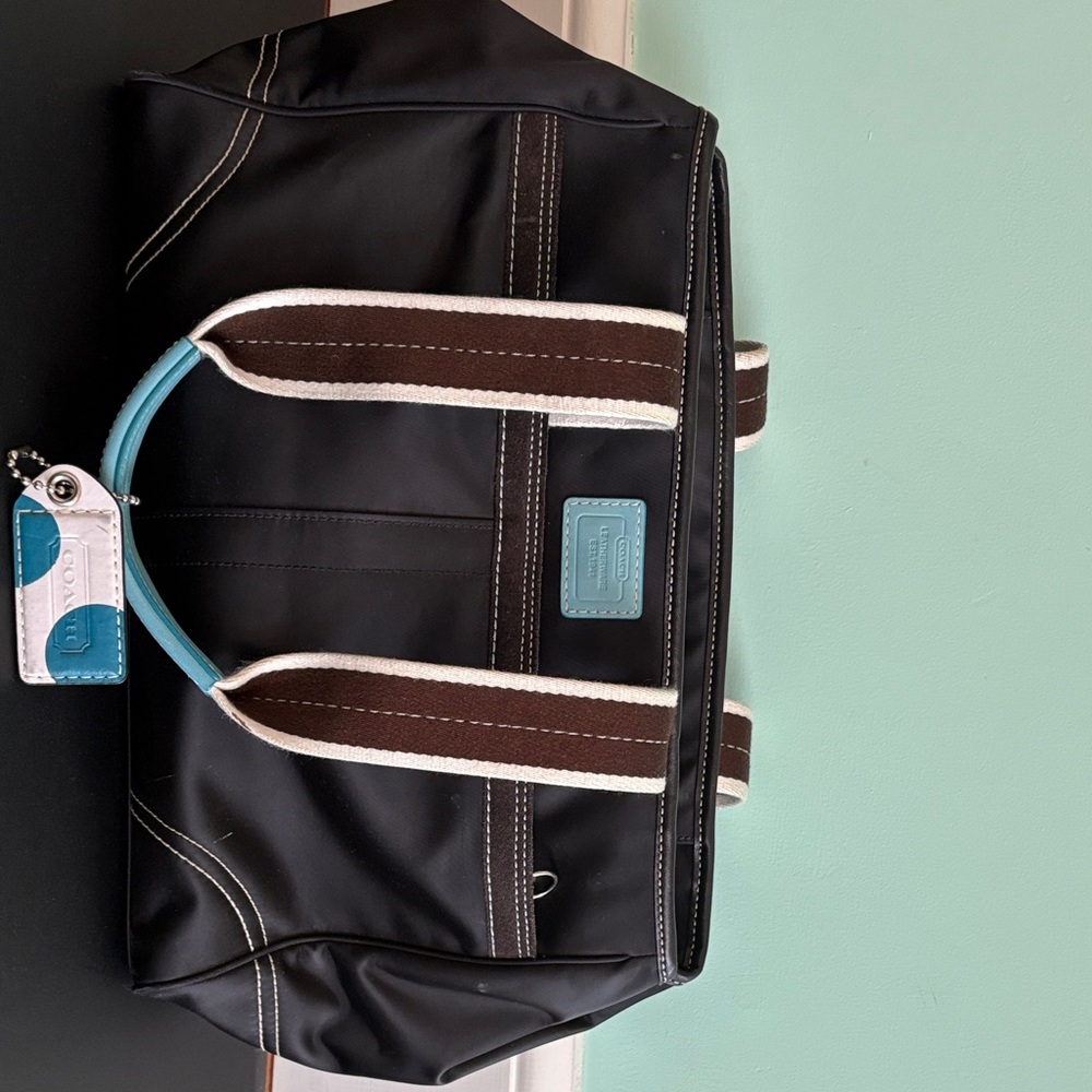 Coach Black Duffel Bag with Brown Straps and Blue Accents
